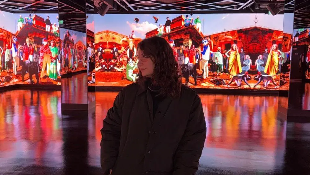 Melody Perry in front of a digital screen