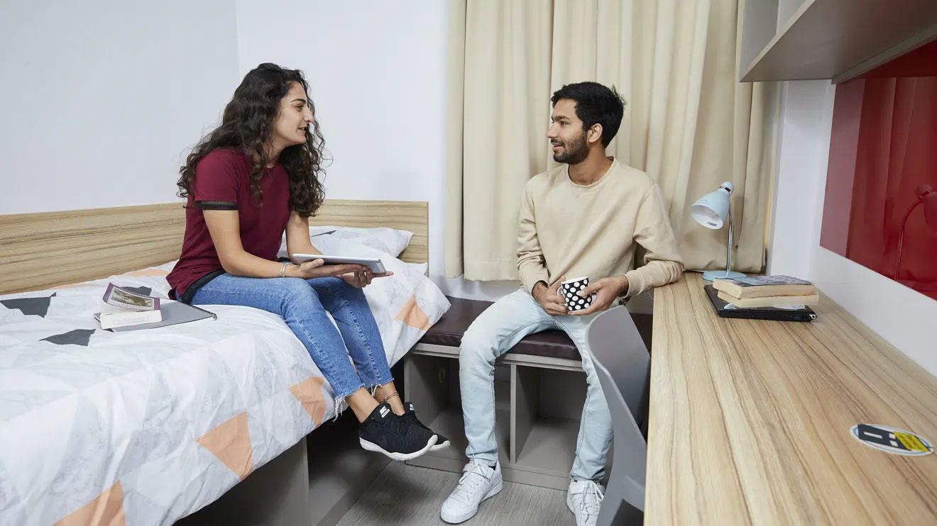 A male and female student in a room in Chantry residence