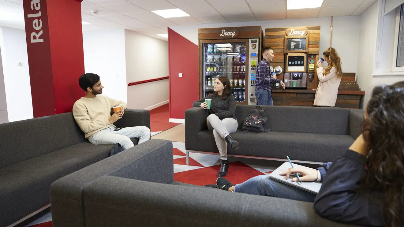 Students socialising in the common room in Kimber residence