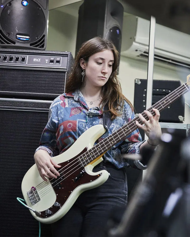 A music production student at a mixing desk
