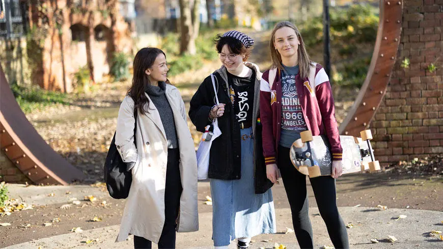 Three female students talking to each other in a location in Southampton