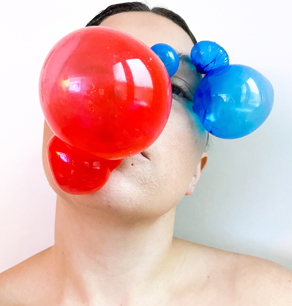 Make-up look created by student Annistasia Chandler showing a woman with blue and red balloons on her face