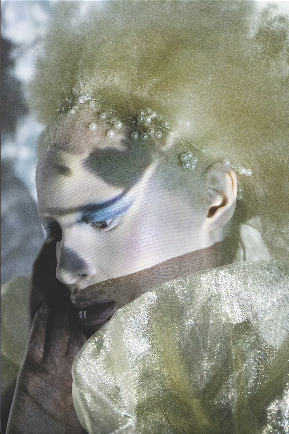Image shows model with white wig, pearls and dramatic make-up 
