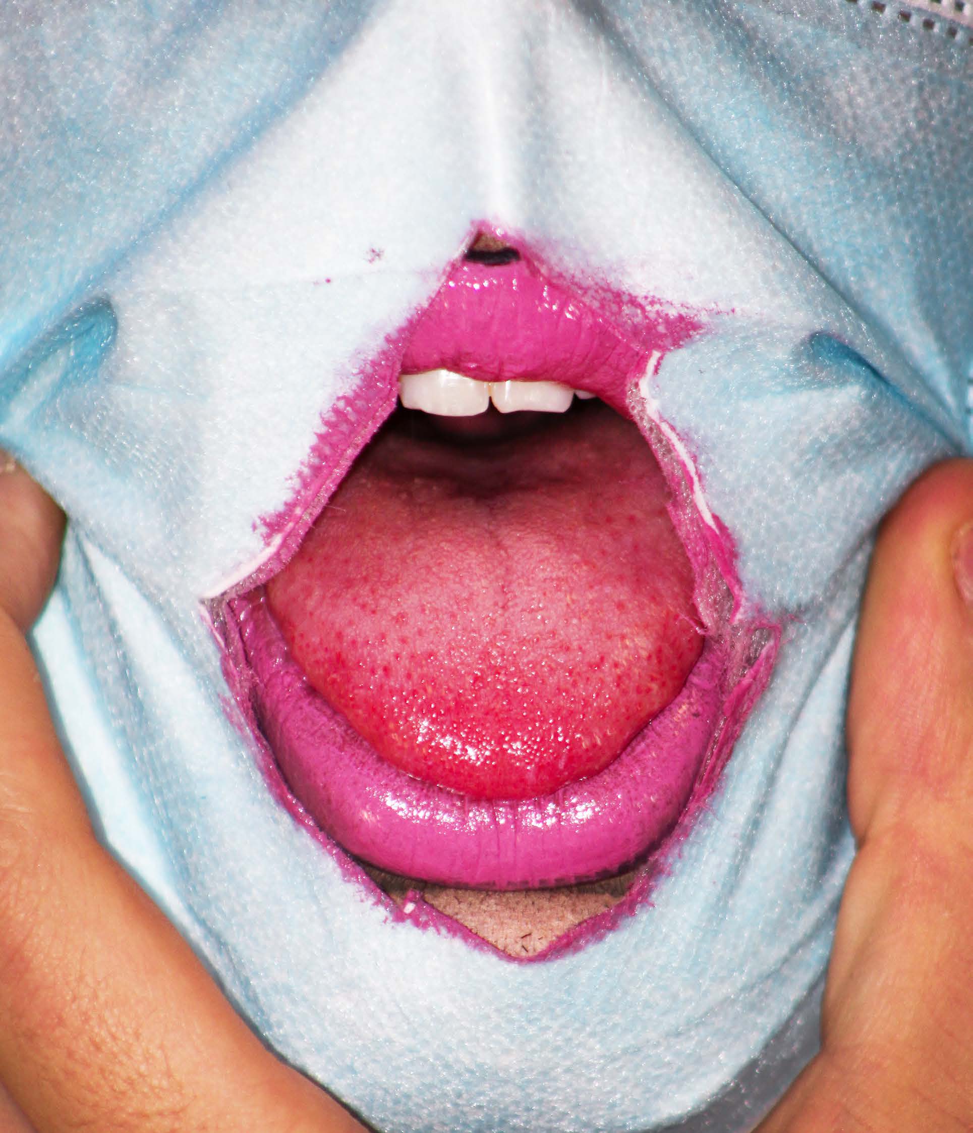Picture shows face mask, with mouth showing through wearing pink lipstick 