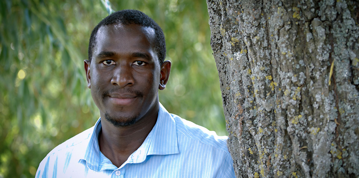An image of Boniface Hima next to a tree