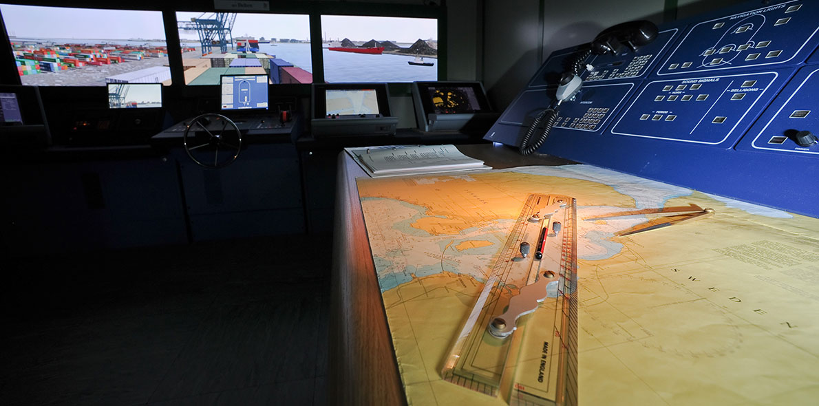 Screens and a chart inside a bridge simulator