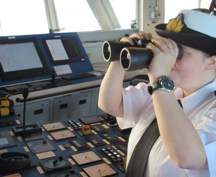 Warsash cadet, Elle Watson using binoculars on the bridge of a ship