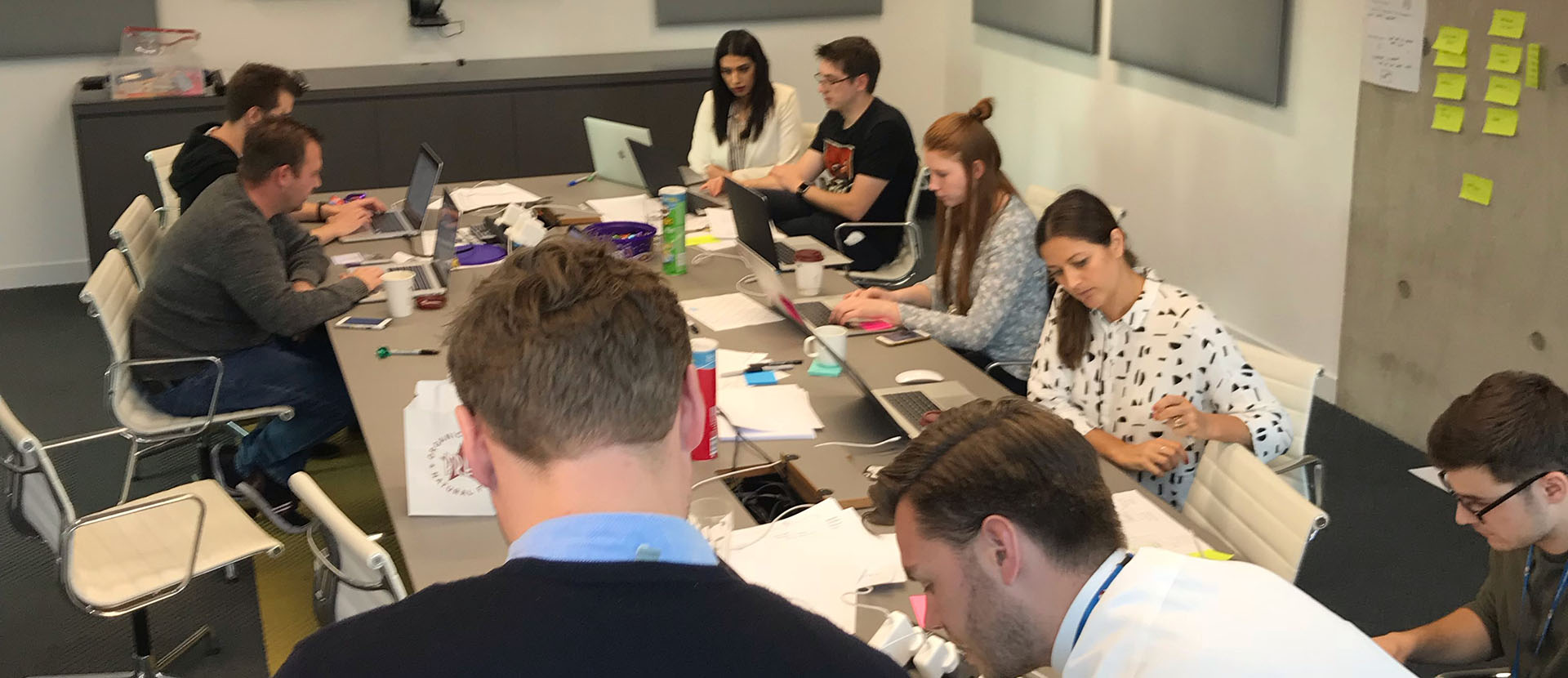 Several people around a table looking at documents