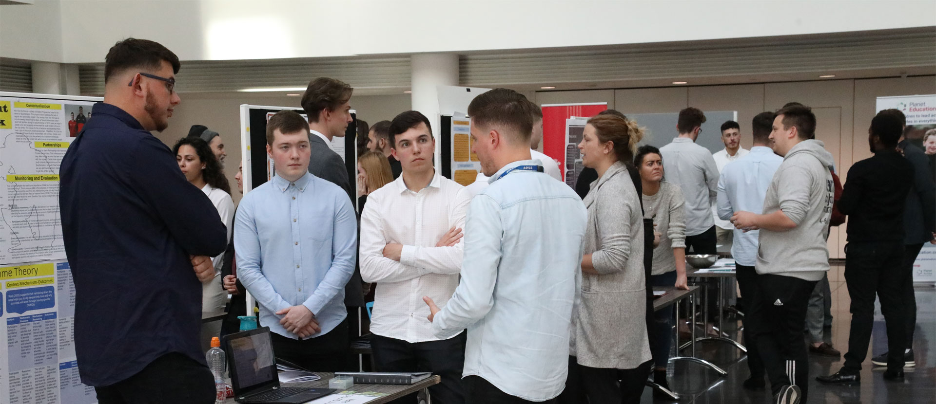 Students talking to guests about their projects at the Community Innovation Symposium
