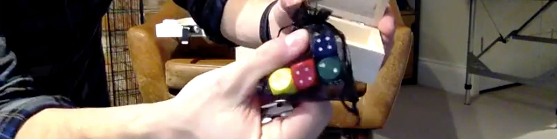 Lecturer, Tom Gray holding a set of dice
