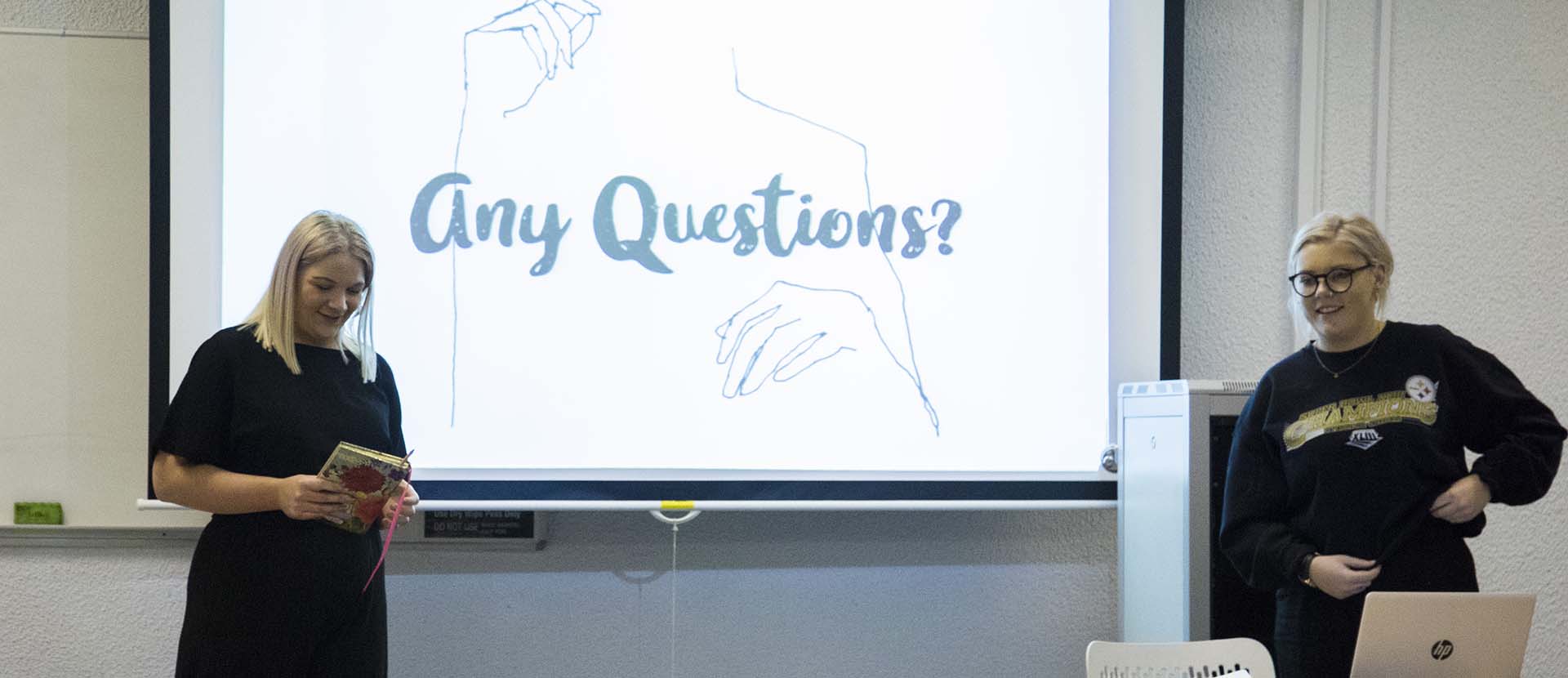 Two fashion students giving a presentation during Fashion as Community week