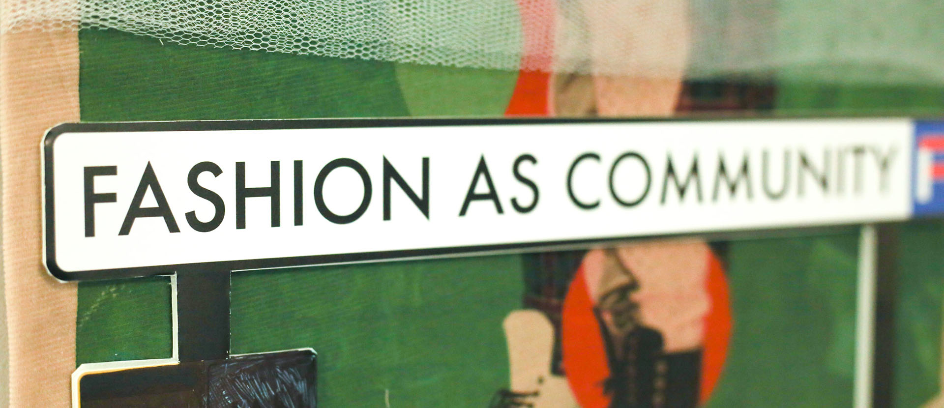 A road sign saying fashion as community - part of a bigger piece of artwork
