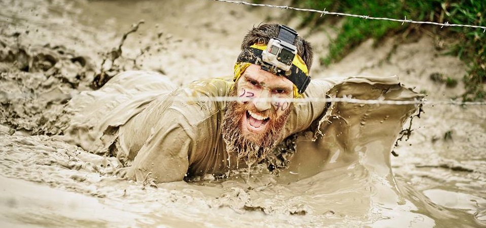 Gil McClure swimming through mud