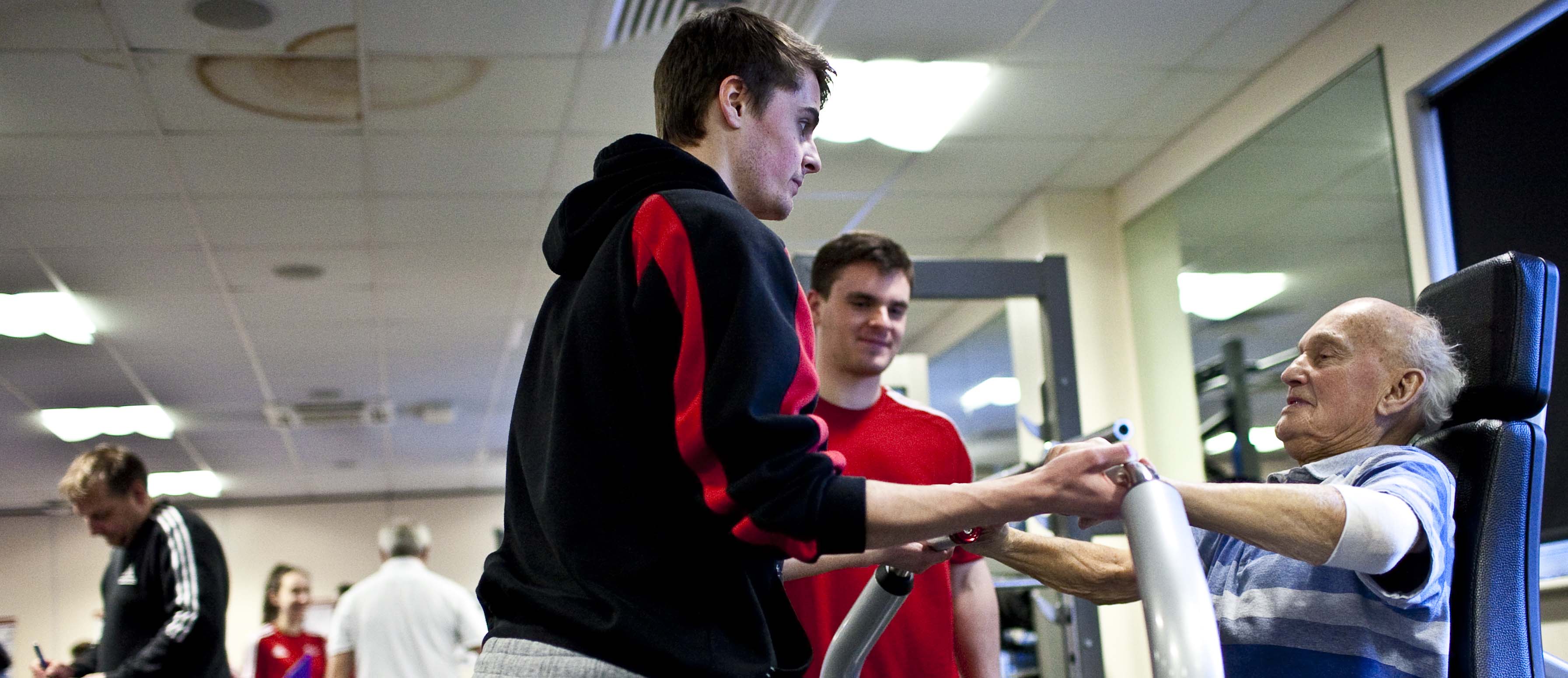 A Solent student working with a client in the teaching gym