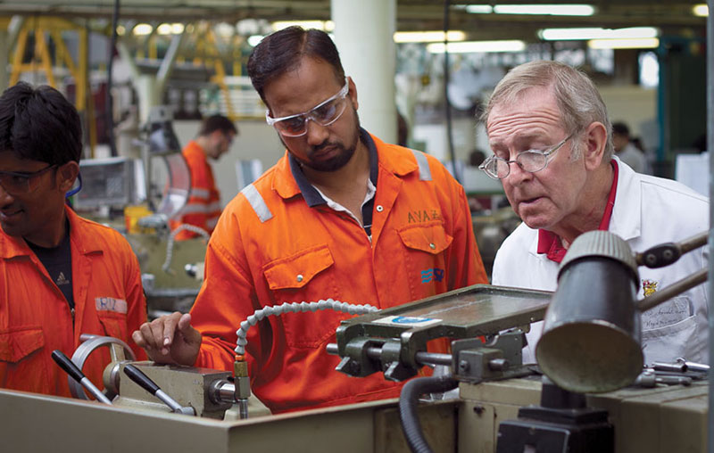 A marine engineer under instruction in the engineering workshop