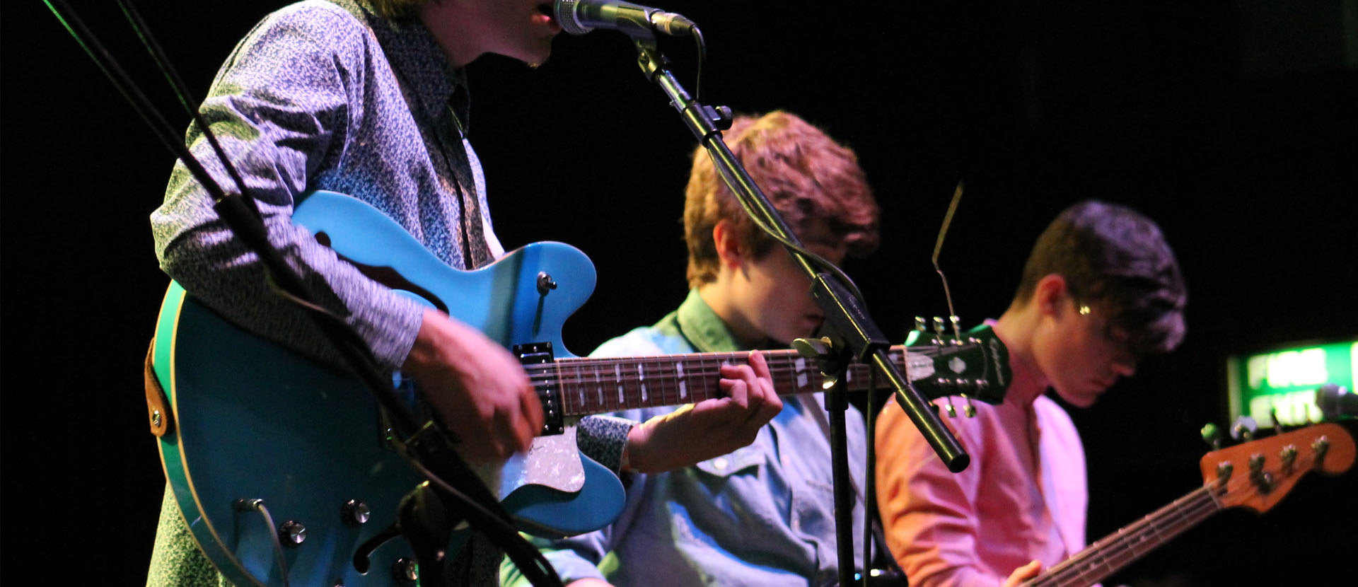 Solent music students performing on stage playing the guitar