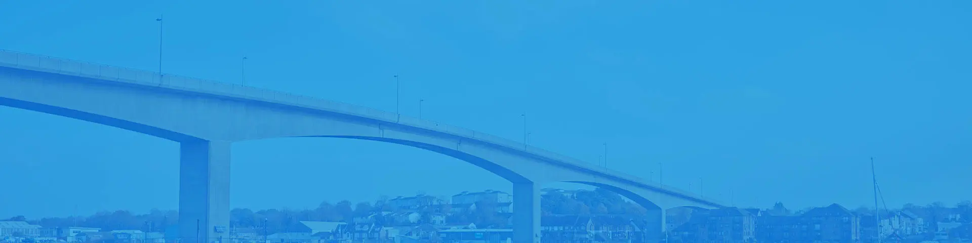 The Itchen Bridge in Southampton with small yachts sailing underneath.
