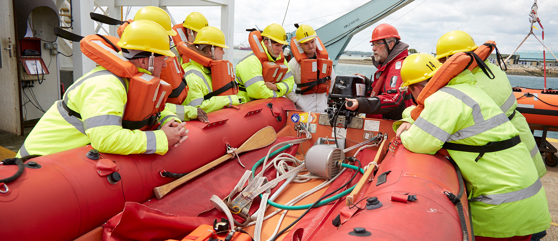 Seafarers training on a survival craft at Warsash wearing PPE equipment