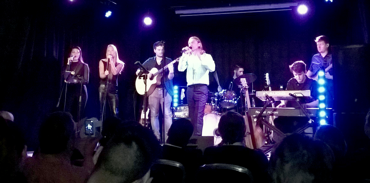 Solent popular music performance alumni on stage with Ryan Molloy