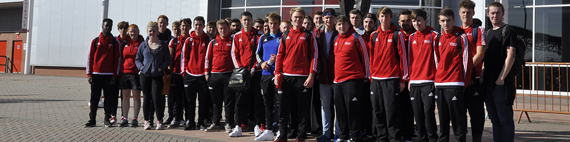 BA (Hons) Sport Coaching and Development students in front of the Ted Bates statue outside St Mary's Stadium
