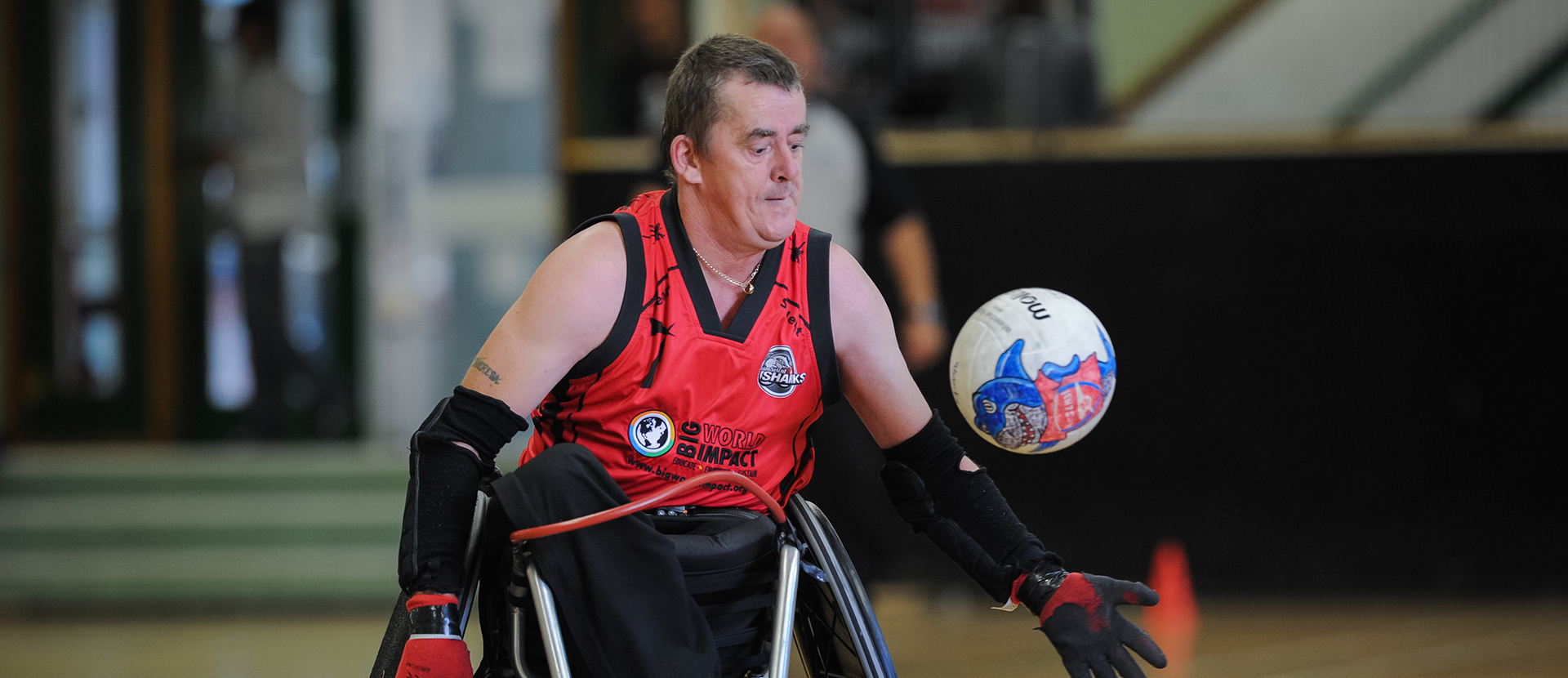 A wheelchair rugby player wearing Josh Steel's gloves during a match