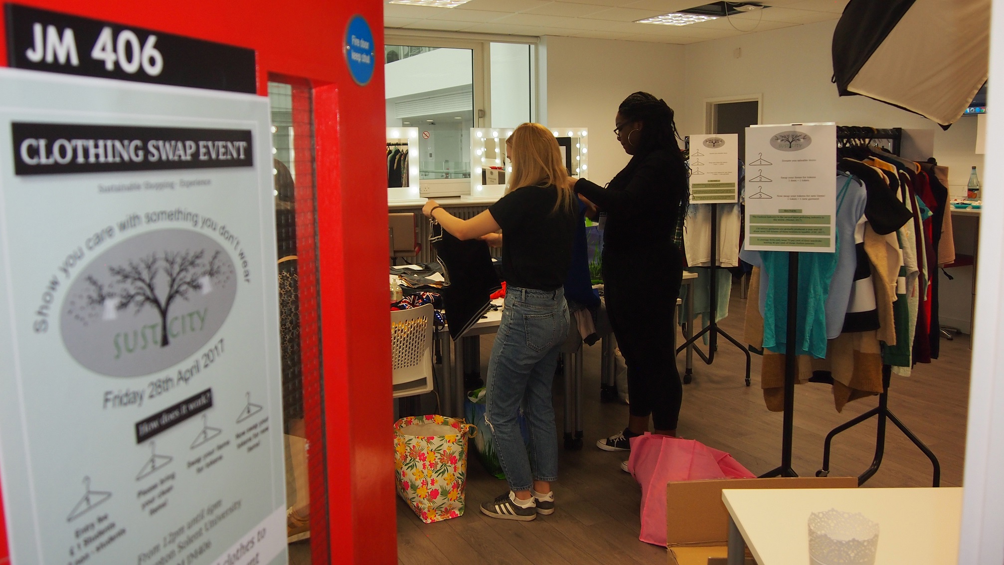 Students browsing through rails at the clothing swap