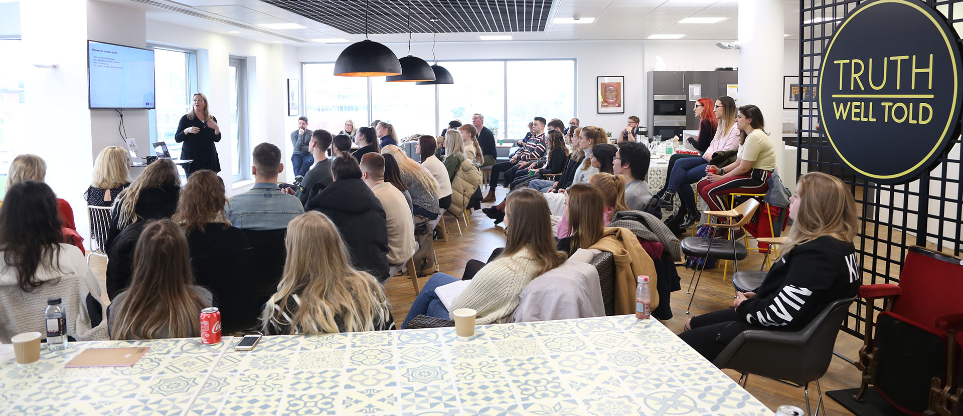 A large group of students sat listening to a presentation