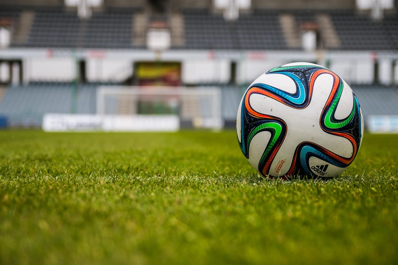 A football on a grass pitch