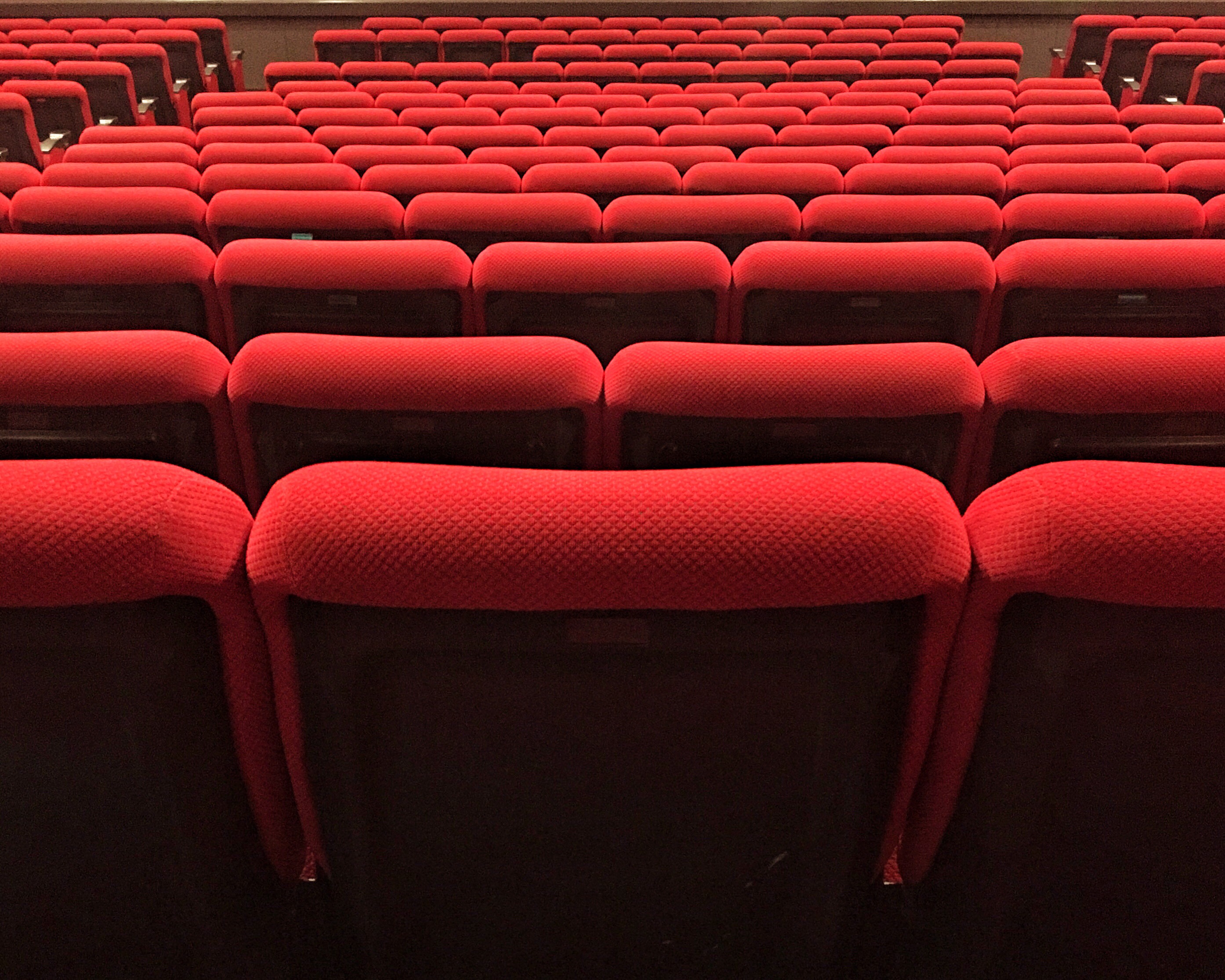Picture shows rows of empty theatre seating 