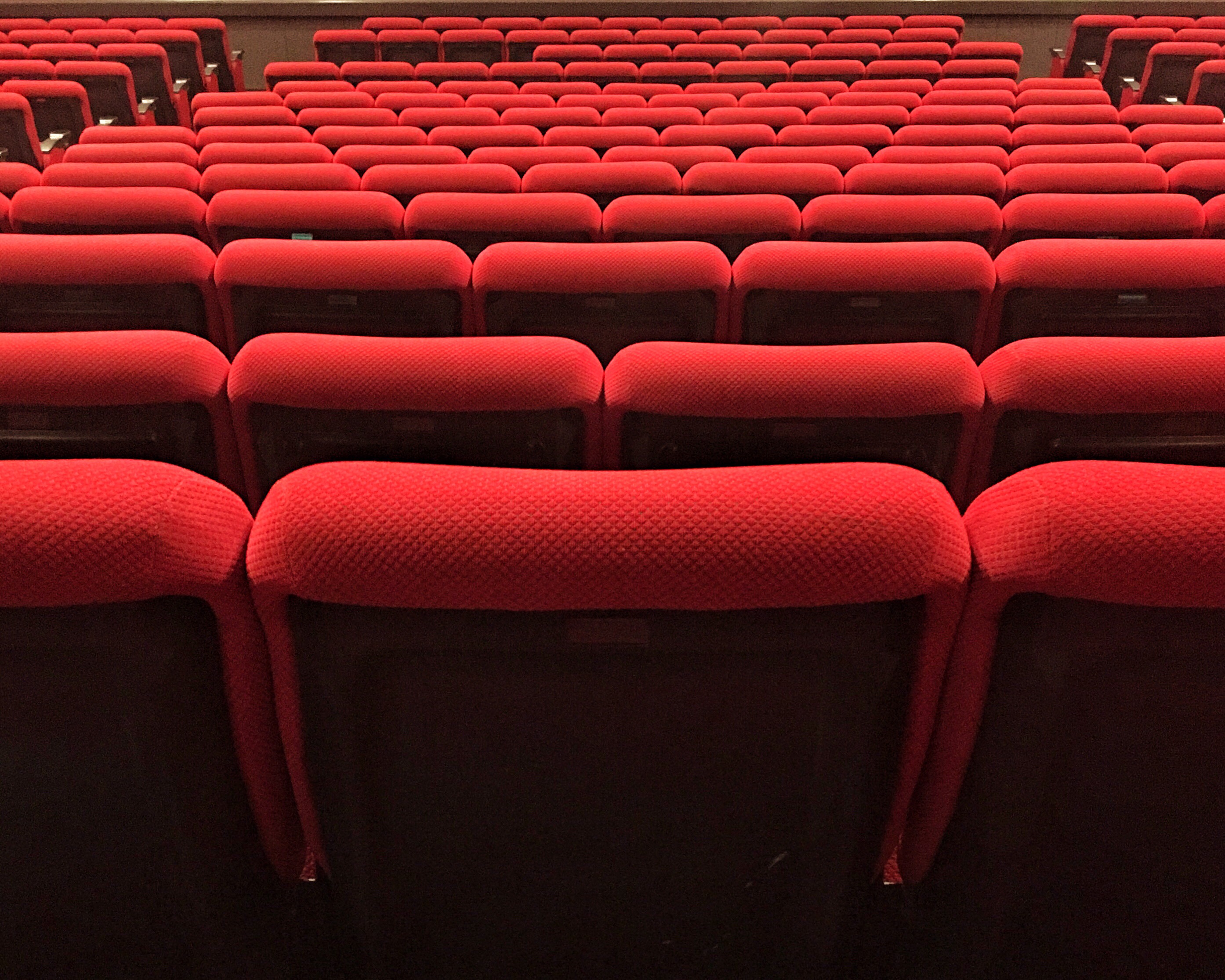 Picture shows rows of empty theatre seating