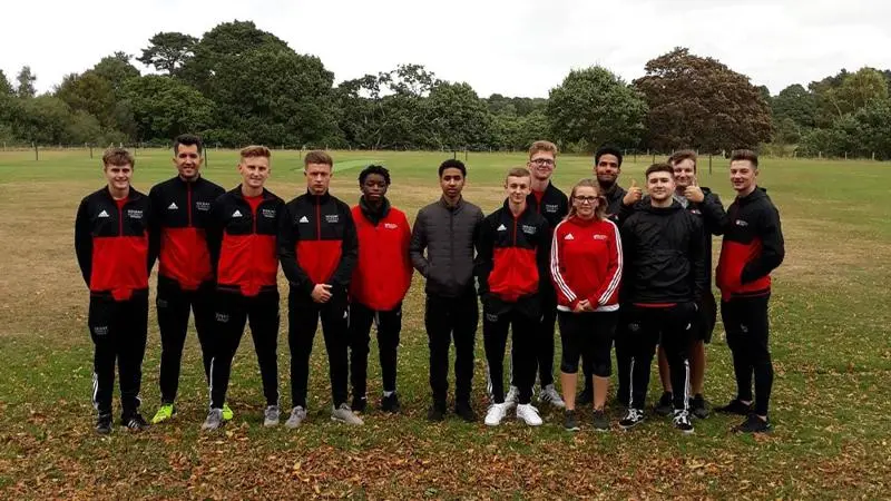 A group of students in a field.