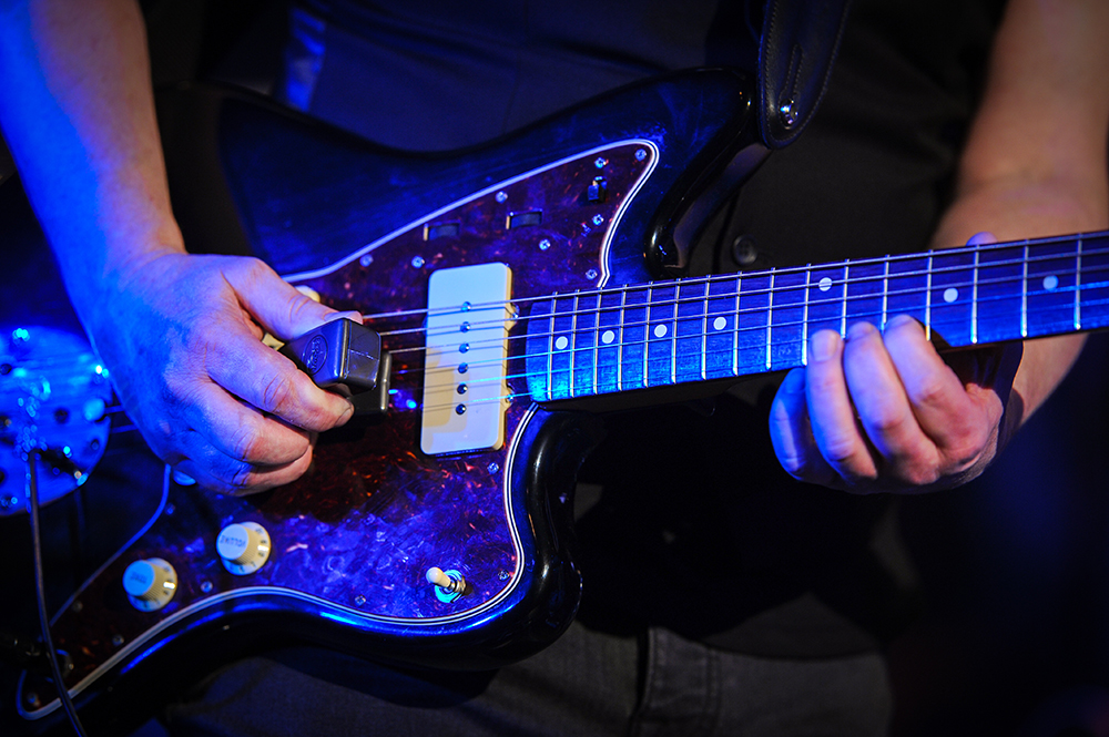 A person playing an electric guitar
