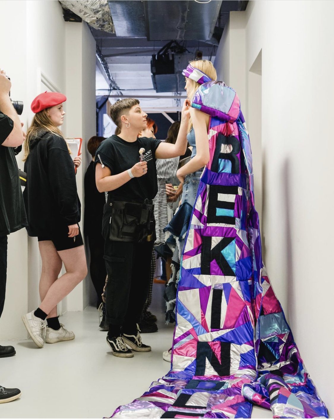 Annistasia Chandler applying make-up to a model while on work experience at London Fashion Week