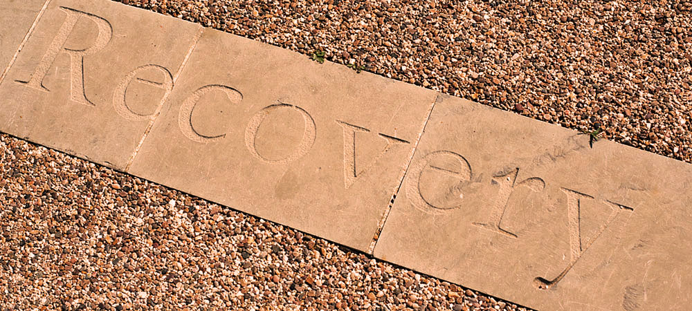 Patio area at broadmoore hospital with the word compassion carved in to the stone. Image credit: https://www.westlondon.nhs.uk/about-west-london-nhs-trust/sites-and-locations/broadmoor-hospital/