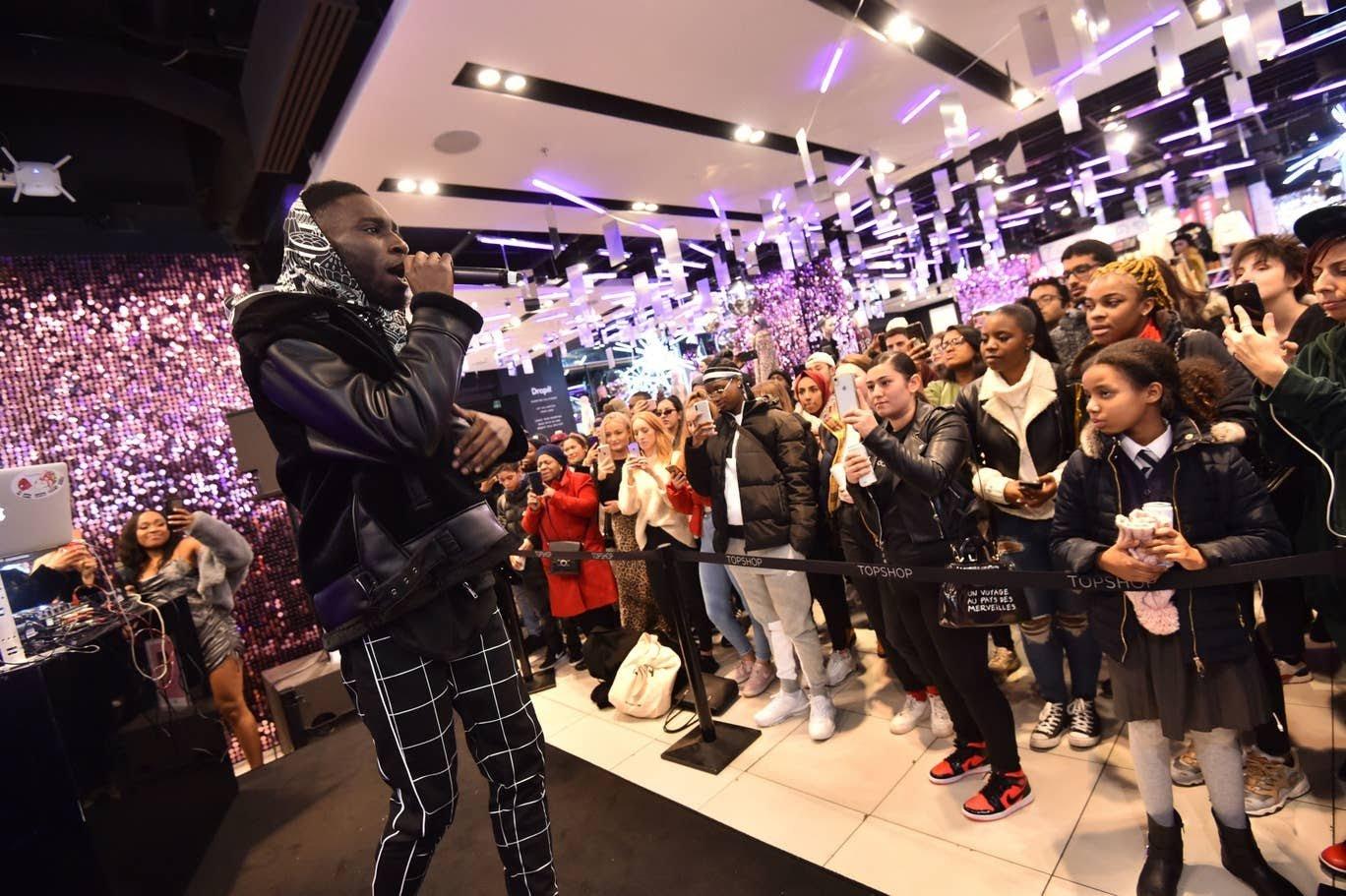 Picture shows musician performing on stage in a Topshop store