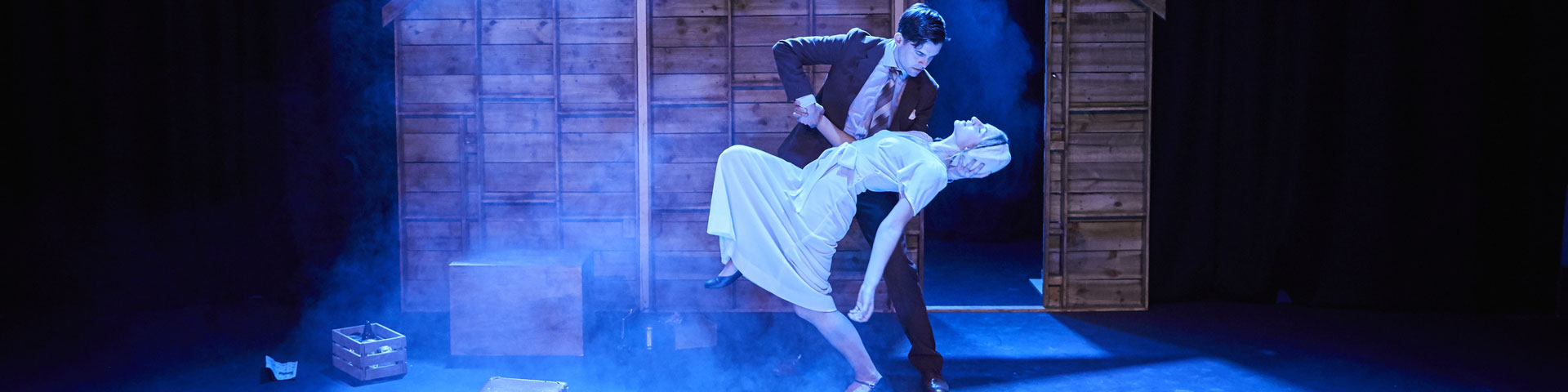 Two people performing on stage in a play