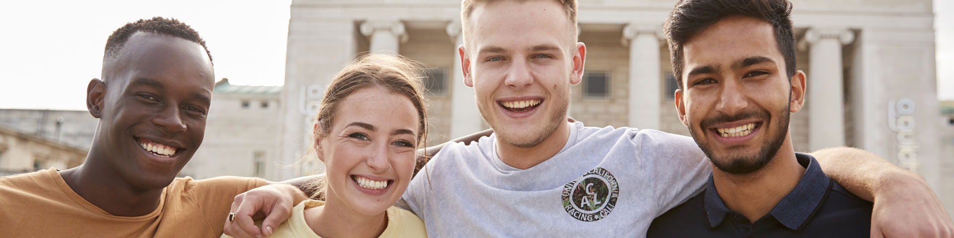 Four students smiling at the camera