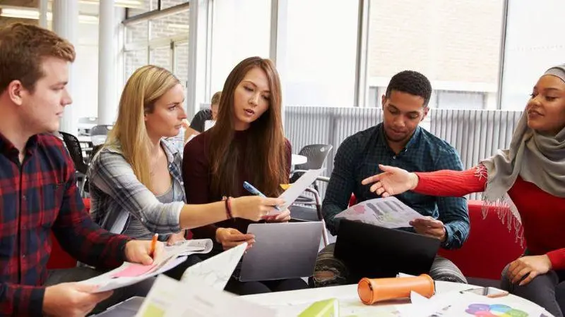 A group of students sat together working on a project