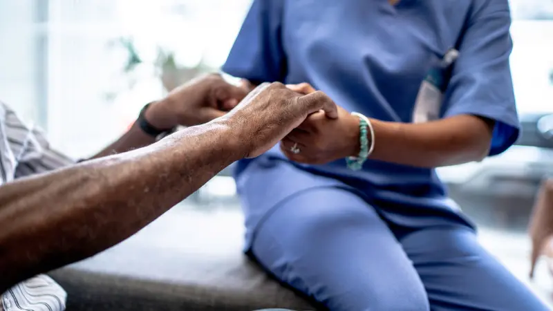 A nurse helping a patient