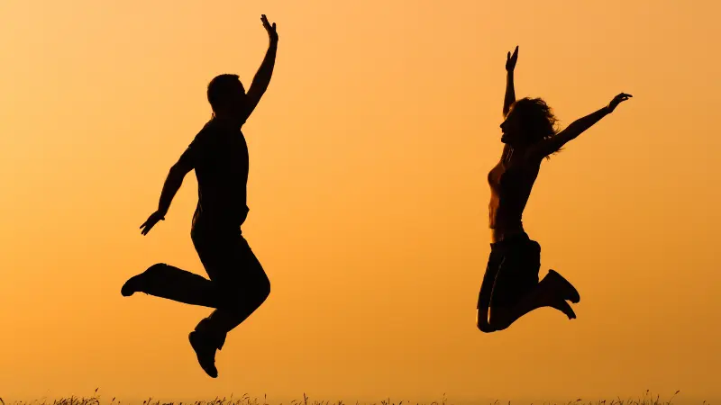 A man and woman jumping for joy