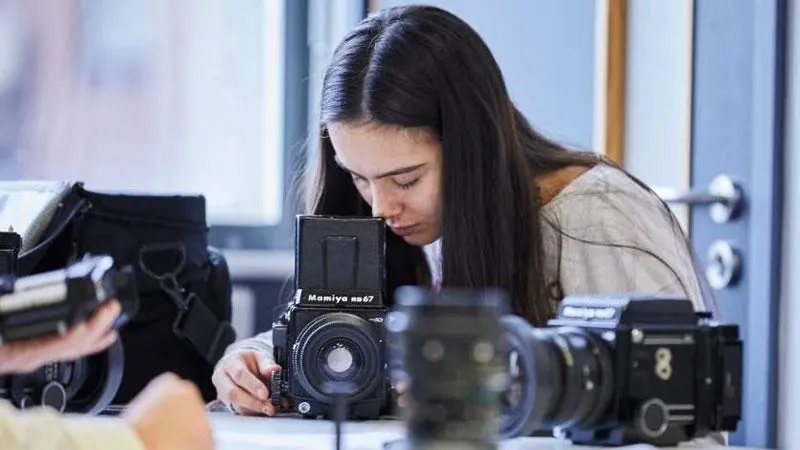 A woman working with photography equipment