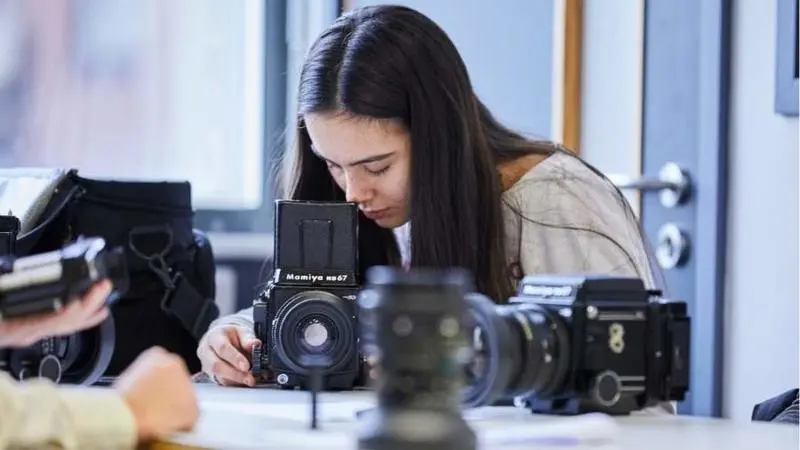 A woman working with photography equipment