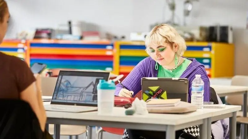 A girl drawing at a desk