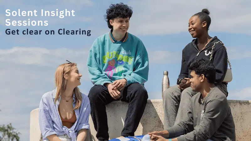 A group of friends sat laughing by a wall