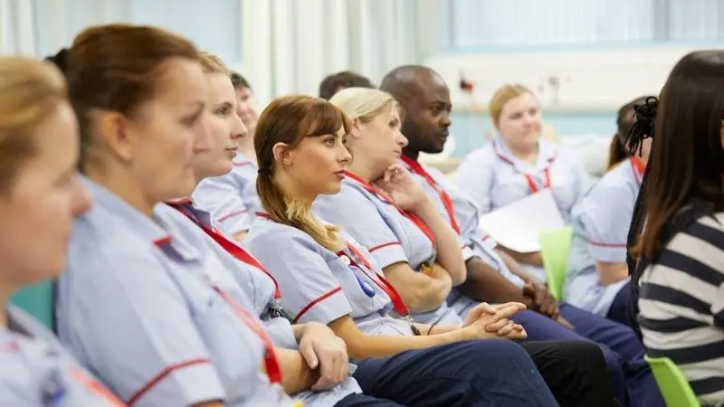 A group of student nurses sat listening