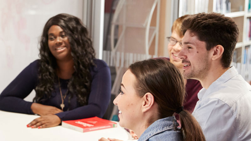 A group of students working in a library room