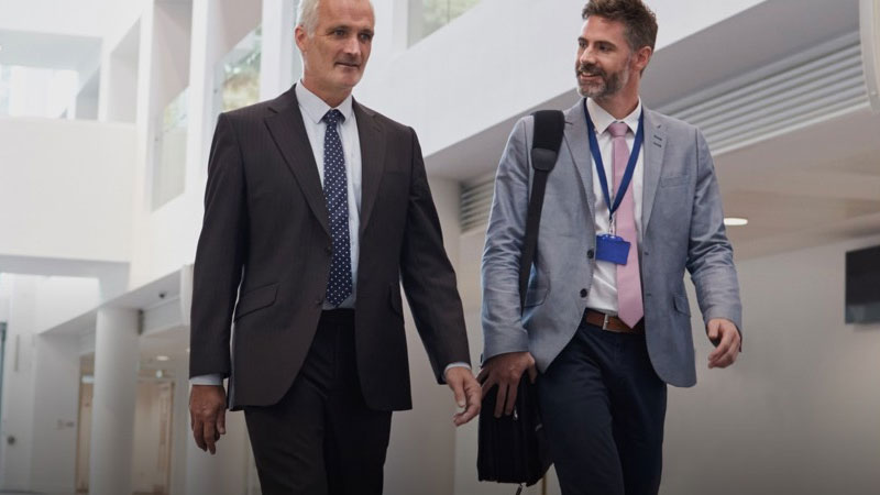 Two male conference attendees walking through The Spark