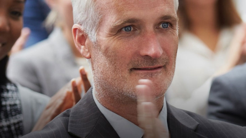 A conference audience member clapping