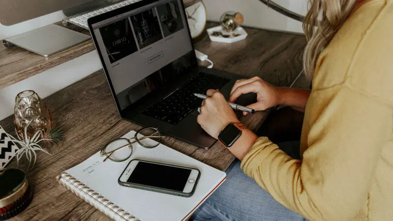 A person typing on a laptop