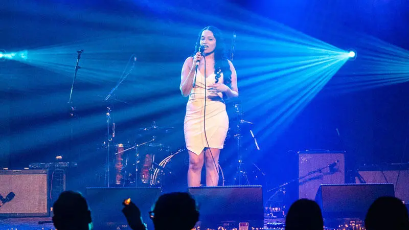A music performance student singing on stage